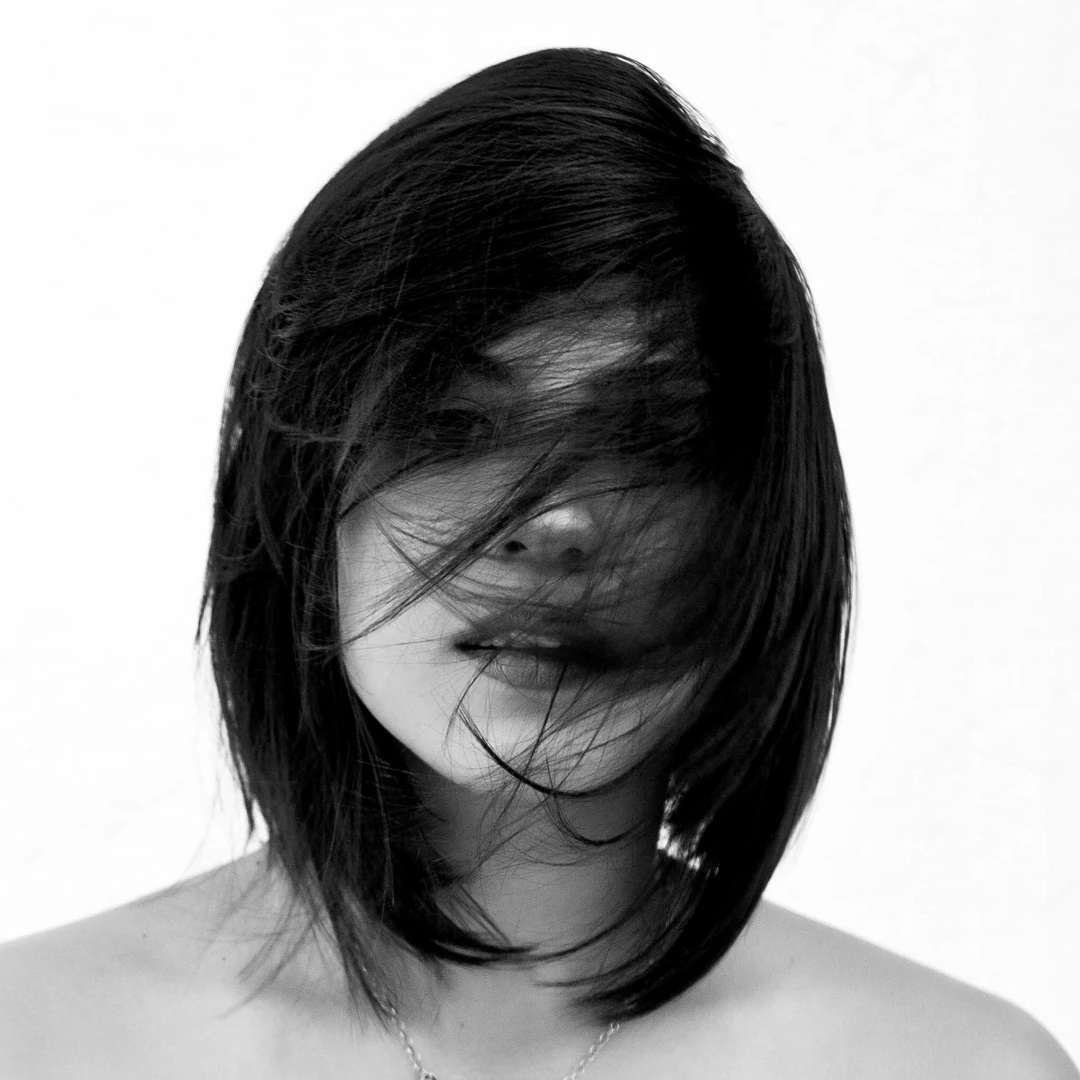 Monochrome portrait of Anastasia with strands of hair across her face